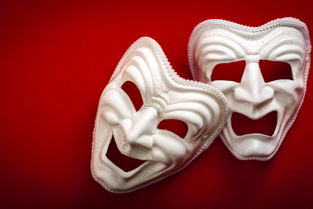 theatrical masks on a red background